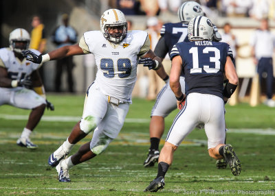 ...Yellow Jackets DE Cummings chases BYU QB Nelson out of the pocket