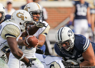 Tech QB Tevin Washington watches the defense as he hands off the ball