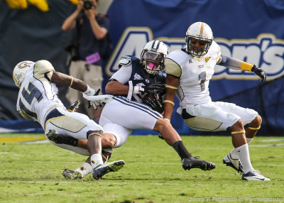 Jackets S Johnson and DB Jemea Thomas stop a BYU receiver after the catch