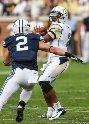 Jackets QB Vad Lee throws under pressure by Cougars LB Spencer Hadley