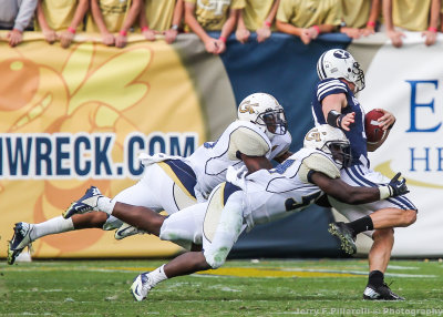 Georgia Tech defensive players bring down a Brigham Young receiver after the catch