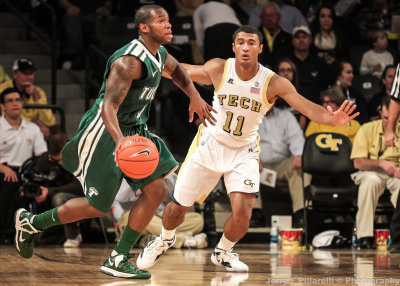 Yellow Jackets G Bolden stays in front of Green Wave G Louis Dabney