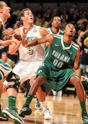 Yellow Jackets C Miller gets boxed out by Green Wave F Davis