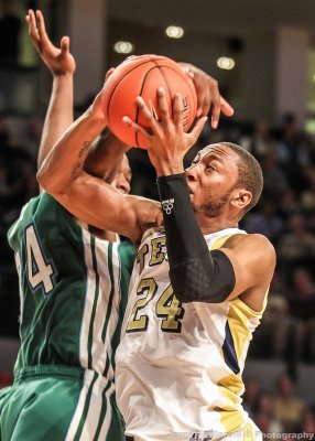 Yellow Jackets F Holsey is fouled by Green Wave F Drye