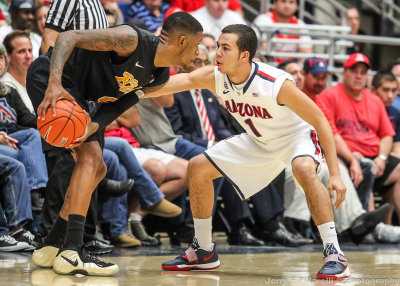 Arizona G Gabe York goes nose to nose on defense with Long Beach State F Kris Gulley