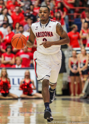 Cats G Lyons brings the ball across center court
