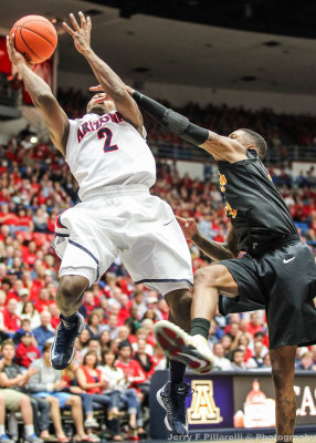 Arizona G Lyons puts up a tough shot under pressure from an LBS defender