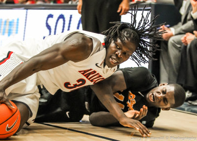 Arizona F Chol goes to the floor to wrestle a loose ball away from LBS F Ennis