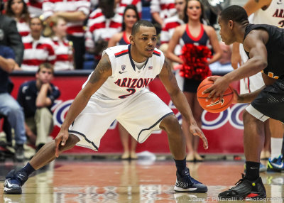 Wildcats G Lyons squares up against a Long Beach State ball handler