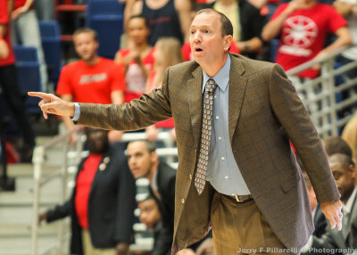 Long Beach State Head Basketball Coach Don Monson instructs from in front of the bench