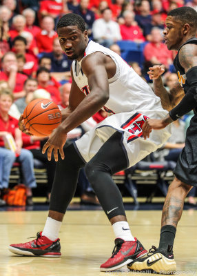Wildcats F Hill moves around a 49ers player along the baseline