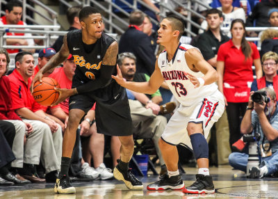 Arizona G Johnson defends Long Beach State F Gulley along the sideline