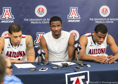 Wildcats F Hill speaks to the press after the game flanked by F Ashley and G Parrom