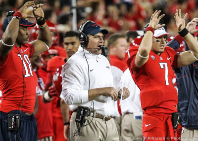 Arizona Wildcats Head Coach Rich Rodriguez communicates with his coaches in the press box