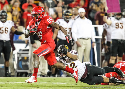 Arizona RB Carey breaks down field past lunging Sun Devils LB Carl Bradford