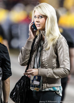 KGUN TV Reporter Kayla Anderson works on the sidelines during the game