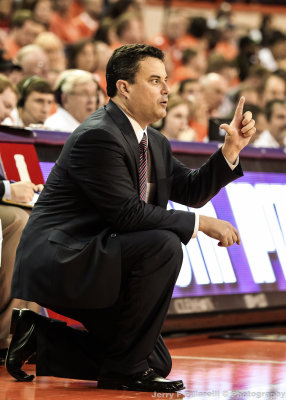 Arizona Head Basketball Coach Sean Miller signals to his team from in front of the bench