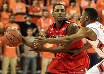 Arizona G Lyons delivers a pass around Clemson G Roper