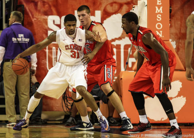 Wildcats C Tarczewski stands his ground against Tigers F Booker as F Hill comes in for the double team
