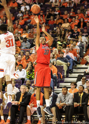 Wildcats F Jerrett steps out and shoots a three pointer over Tigers F Booker