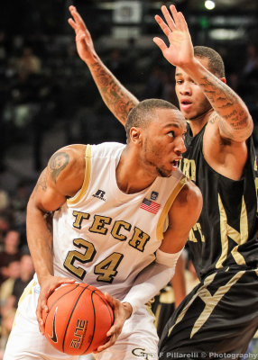 Tech F Kammeon Holsey moves to the basket against a Hornets defender