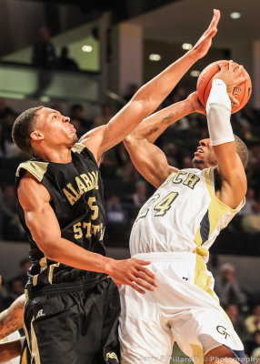 Hornets F Bobby Brown attempts to block a Jackets F Holsey shot