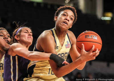Yellow Jackets F Aallyah Whiteside gets fouled by a Huskies player after a rebound
