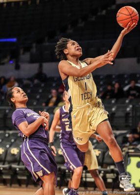 Jackets G Maye lays the ball up on the break with Huskies trailing the play