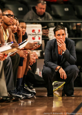 Georgia Tech Head Coach MaChelle Joseph watches play from in front of the bench