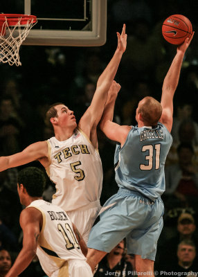 Jackets C Daniel Miller goes up to block a shot by Bulldogs C Mike Groselle