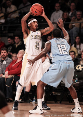 Yellow Jackets G Jordan looks for an open teammate while Bulldogs G Ashton Moore defends