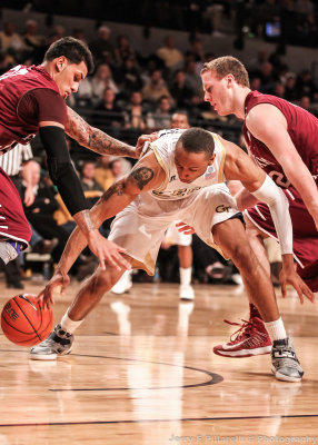 Jackets F Holsey wrestles with Rams defenders for a loose ball