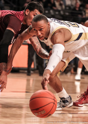 Georgia Tech F Holsey dives past a Fordham defender to get control of a loose ball