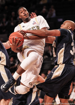 Yellow Jackets F Robert Carter Jr. drives the lane on Mocs F Jared Bryant