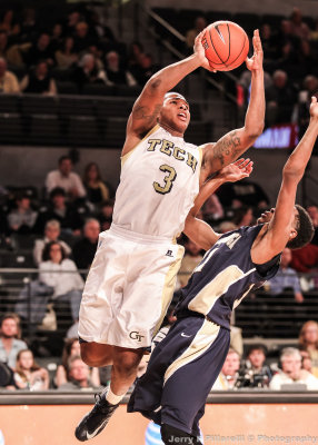 Yellow Jackets F Marcus Georges-Hunt shoots over Mocs G Ronrico White
