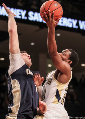 Jackets G Reed attempts to lay the ball in over Mocs F Watson