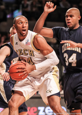 Yellow Jackets F Holsey looks to make a move under the basket as Mocs F Bryant defends
