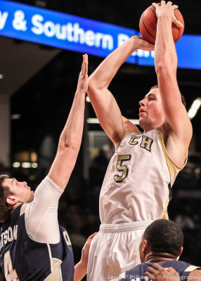 Jackets C Miller puts up a short jumper over Mocs F Watson