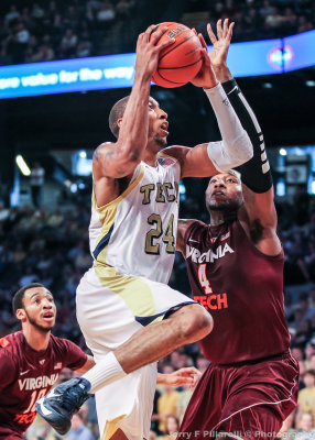 Yellow Jackets F Kammeon Holsey goes to the basket against Hokies F Raines…