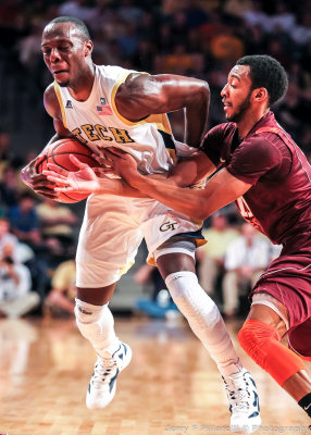 Yellow Jackets G Udofia is fouled by a Hokies defender
