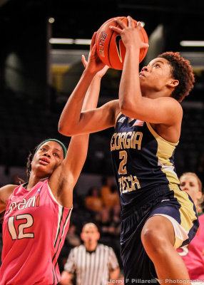 Yellow Jackets G Whiteside goes in for the layup against Hurricanes G Krystal Saunders