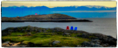 Lounge chairs, picnic table and a house