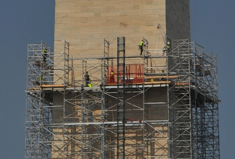 Workers repairing earthquake damage on the Washington Memorial (about 300 above the ground)