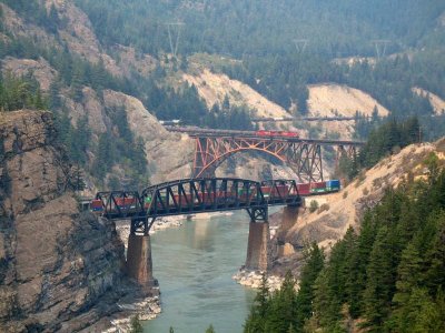 Two trains meet on the bridges at Cisco BC, above the Fraser River. Forest fire smoke fills the canyon. 9-3-06