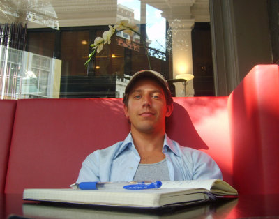 the man, the cafe, the journal, the hat