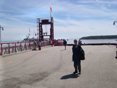 Judy on a pier at Baie Ste-Catherine, waiting for the boat to take us whale watching.