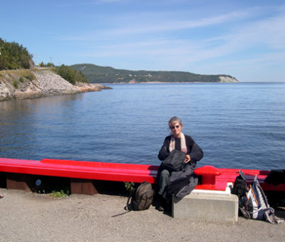 Judy on a pier at Baie Ste-Catherine, waiting for the boat to take us whale watching.