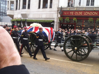 The coffin comes into view on the gun carriage