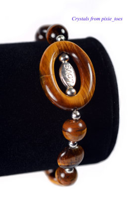 Tiger's Eye - a 26x20mm ring focal bead, with a 'love' bead inside, and assorted Tiger's Eye beads plus silver-plated beads