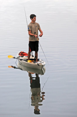 Young Solo Fisherman with Reflection